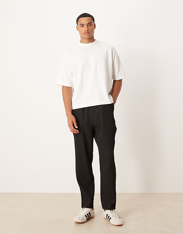 ASOS DESIGN plisse tapered trousers in black