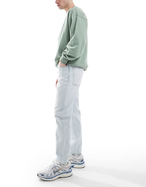 ASOS DESIGN Tapered Jeans In Bleach Wash Blue