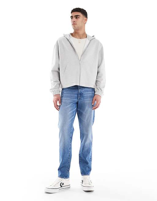 ASOS DESIGN tapered jeans in light wash blue