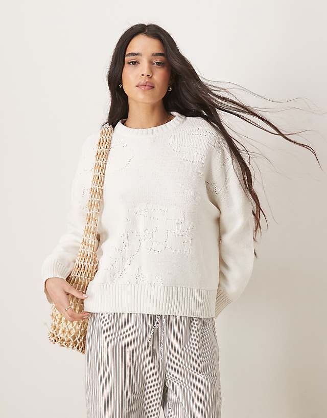 ASOS DESIGN knitted crew neck jumper with flower stitch in cream