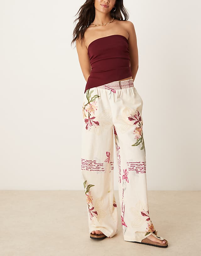 ASOS DESIGN linen blend pull on wide leg trousers with shirred waist detail in floral print