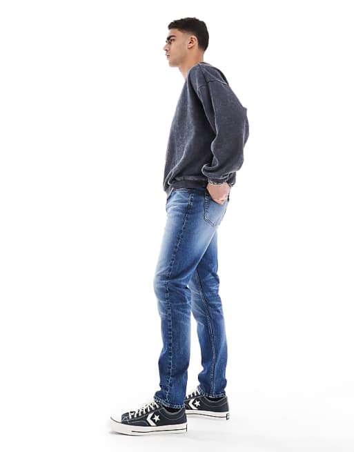 ASOS DESIGN Skinny Jeans With Tint In Mid Wash Blue