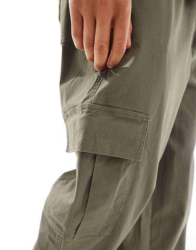 ASOS DESIGN Super Baggy Cargo Trousers With Elasticated Waist In Washed Green