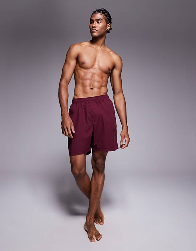 ASOS DESIGN swim shorts in long length in burgundy