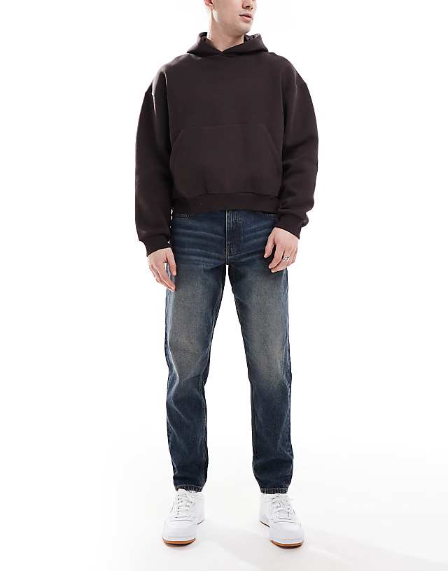 ASOS DESIGN tapered jeans with vintage tint in dark wash blue